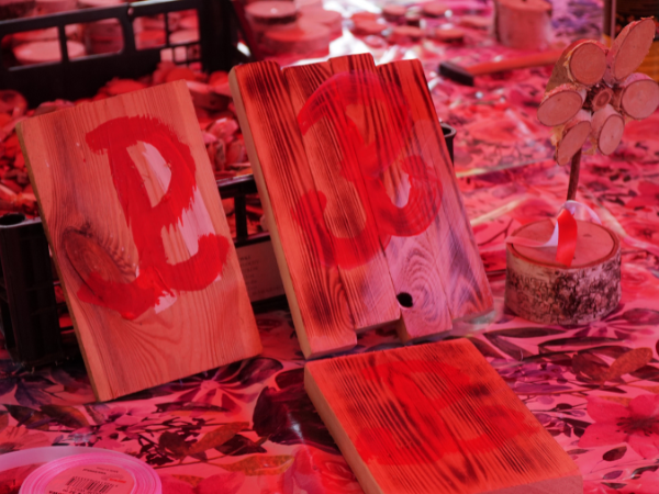 Drewniane tabliczki z czerwonym znakiem "Polska walcząca" namalowanym farbą